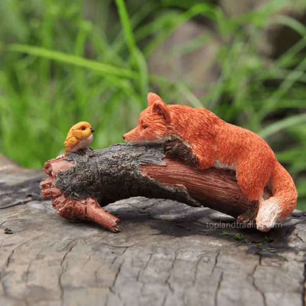 Playful Red Fox with Bird Statue